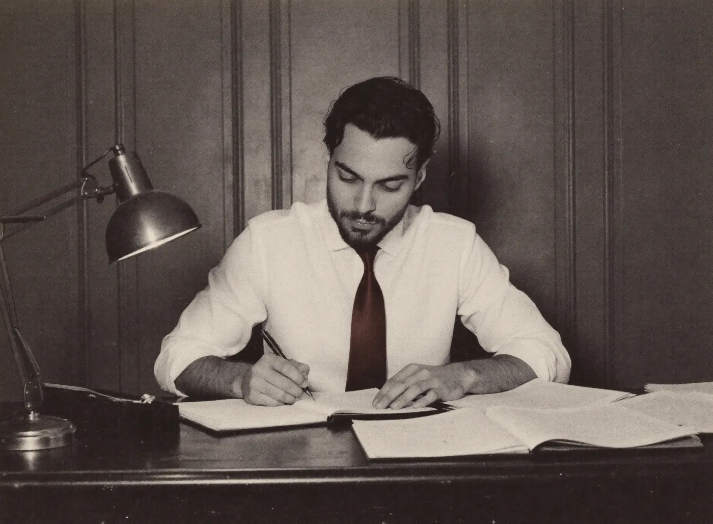 Isaac Lasry writing at a desk
