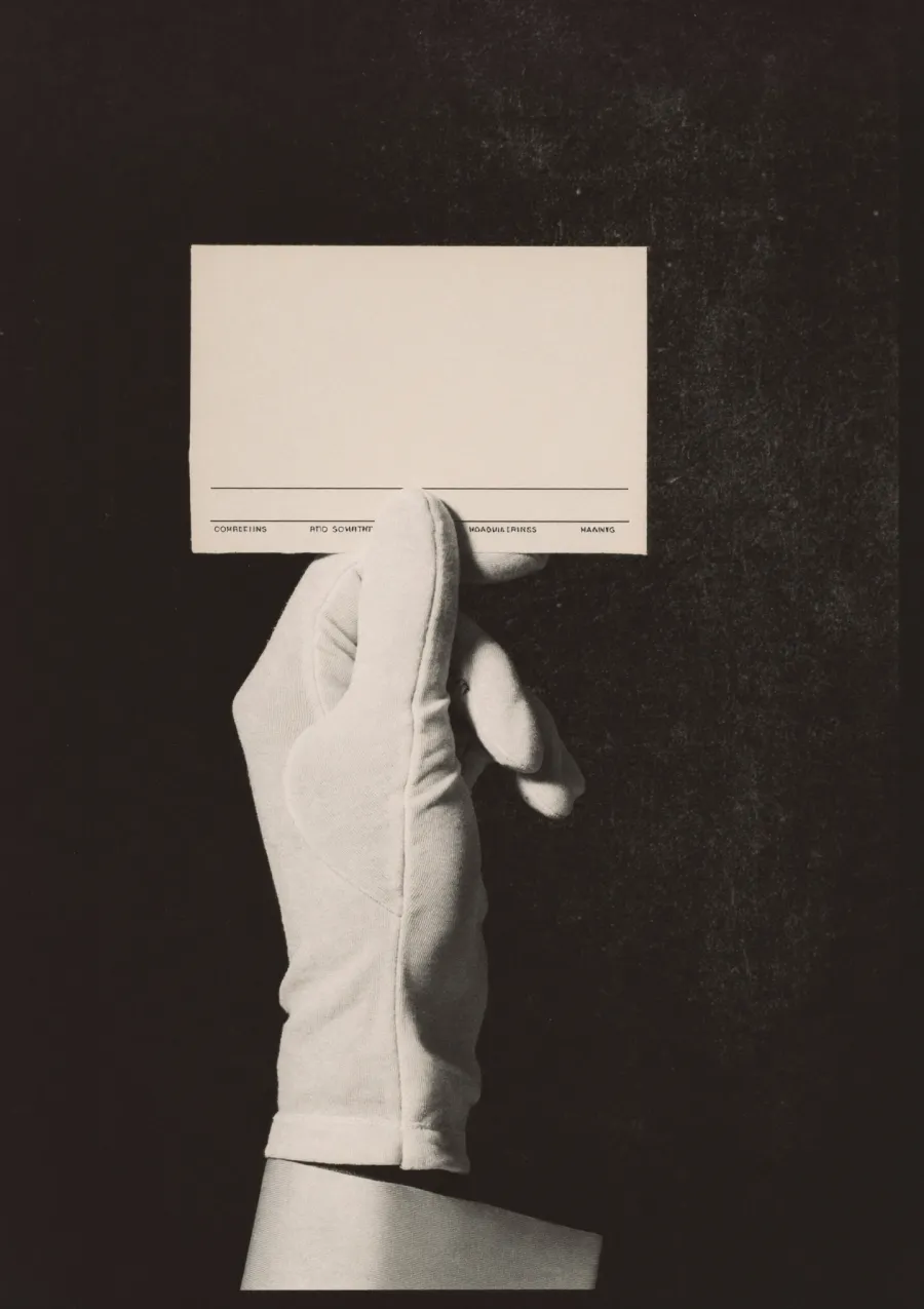 A gloved hand holding a card